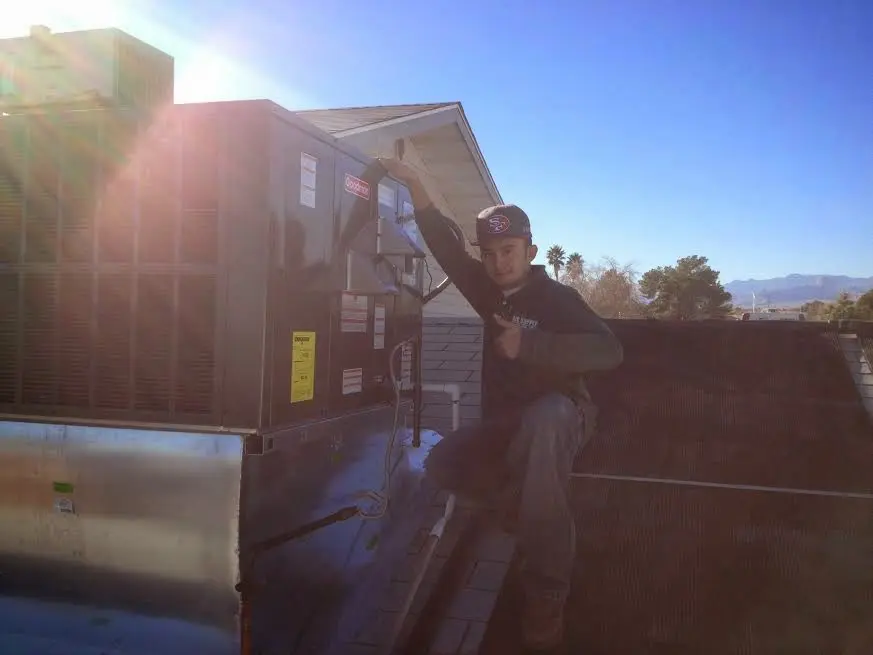 HVAC technician performing HVAC Inspection on a rooftop unit in Millersville